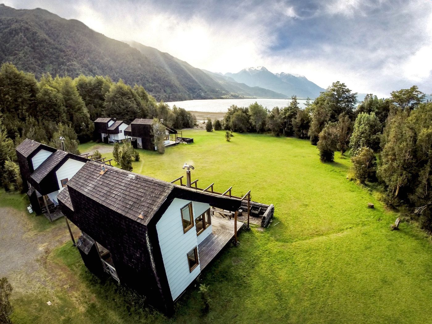 Aerial view of Yelcho’s cabins on the meadow by the lake