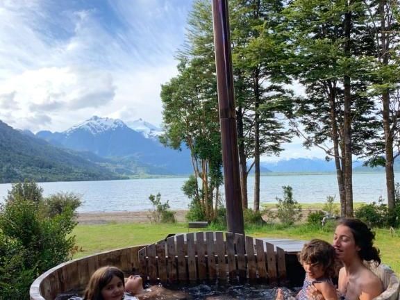 Wooden hot tub with Lake Yelcho in the background